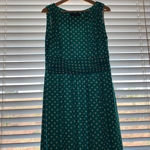 Green with white polka dot, sleeveless dress.
